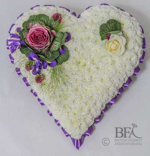 Solid White Heart Tribute with Ribbon Edge and Corner Spray  Description: